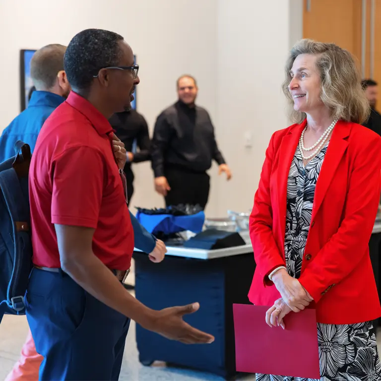 Associate Vice President Philemon and President Whitten talk at a catered event