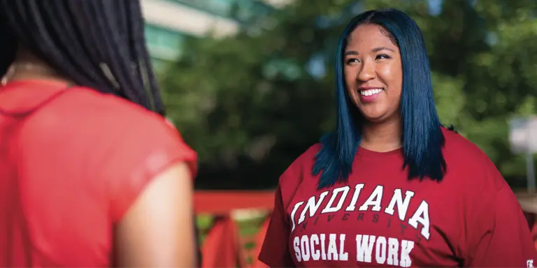 A smiling female in an IU School of Social Work sweatshirt